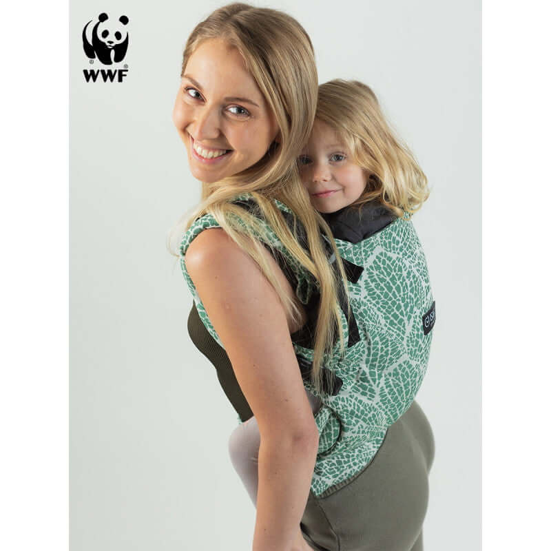 Isara The One - Majestic Green Forest baby carrier being used by a happy parent with child, supporting from birth to preschool | Babymaxi