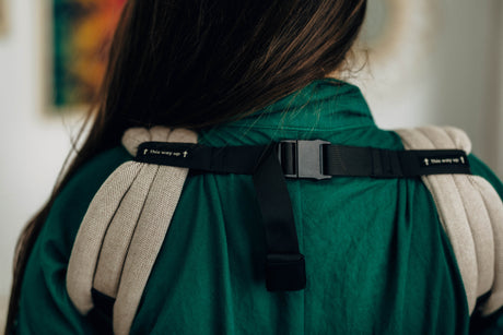 Close-up of LennyLight baby carrier straps showing adjustable buckle and soft padding.