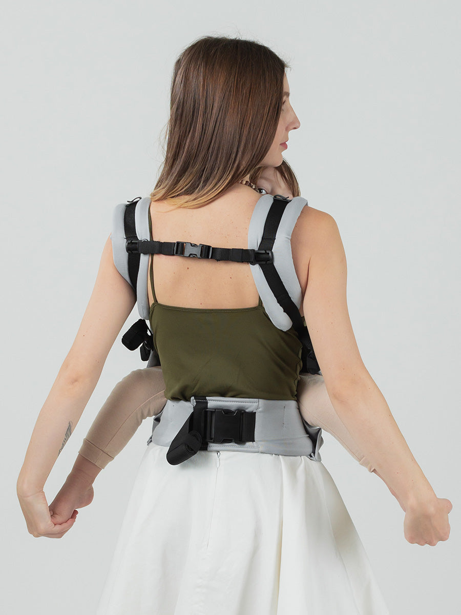 Isara Preschooler - Pearl Grey baby carrier being worn, showcasing adjustable design and child on the back | Babymaxi