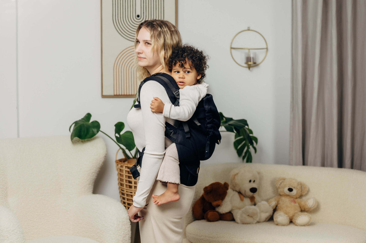 Mom using LennyLamb LennyPreschool (up to 30kg) - Little Herringbone Ebony Black carrier with toddler on her back | Babymaxi