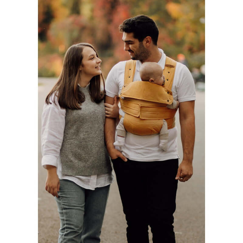 Marsupi Classic - Butterscotch baby carrier in use by a couple outdoors | Babymaxi