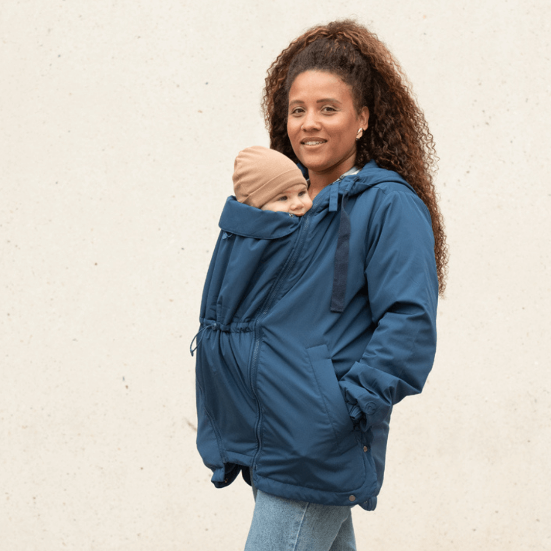 Mamalila Boston Babywearing Jacket - Navy worn by a smiling mother carrying her baby, versatile design for motherhood | Babymaxi