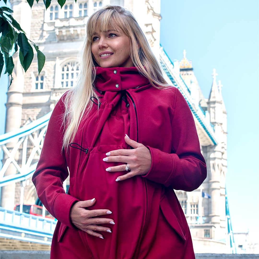 Wombat & Co. London - Shell Babywearing Coat - Cherry Red worn by pregnant woman outdoors | Babymaxi