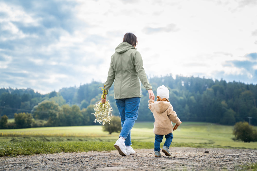 Mamalila Softshell Babywearing Jacket Allrounder Fit Agave, mom walking hand in hand with toddler, back view