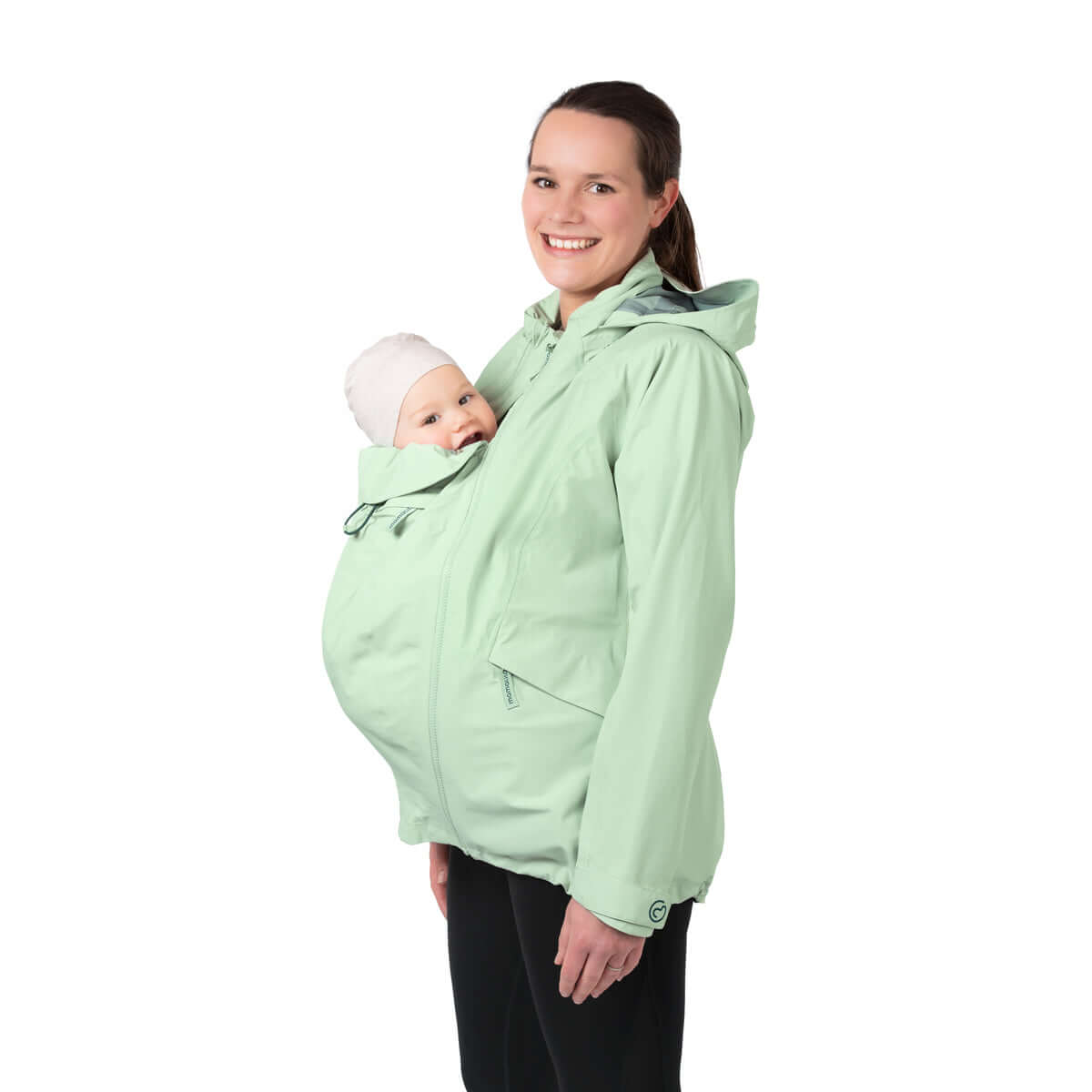 Mamalila Explorer Outdoor Baby Carrier Jacket - Mint worn by a smiling mother with her baby snug inside | Babymaxi