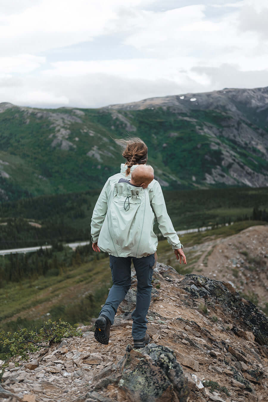 Woman hiking in the mountains with baby in Mamalila Explorer Outdoor Baby Carrier Jacket - Mint | Babymaxi