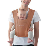 Ergobaby Embrace - Canyon Clay baby carrier worn by a father with a smiling baby, perfect for comfort and ease of use | Babymaxi