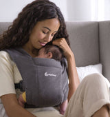 Ergobaby Embrace - Heather Grey baby carrier with woman holding newborn closely | Babymaxi