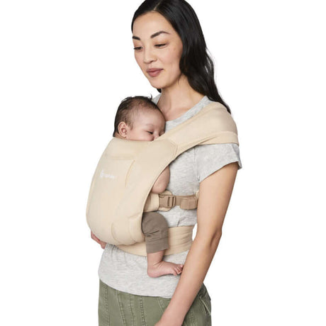 Mom comfortably carries baby in Ergobaby Embrace Soft Air Mesh - Cream for secure and breathable support | Babymaxi