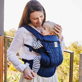 Mom using Ergobaby Omni Breeze - Midnight Blue baby carrier with soft mesh for comfort and breathability | Babymaxi