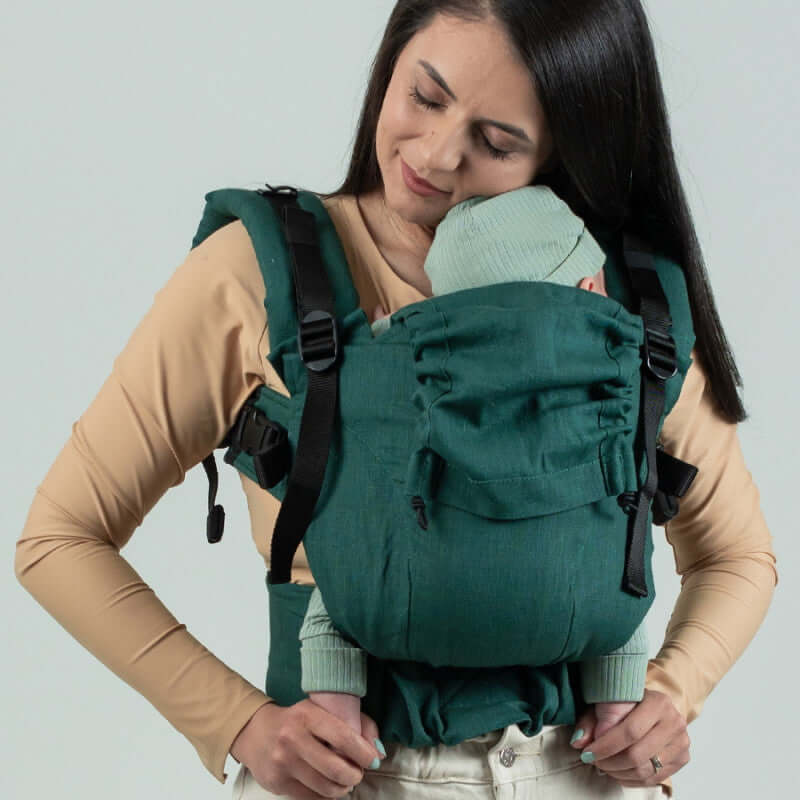 Isara The One - Evergreen Linen baby carrier worn by a parent with an infant, showcasing comfort and support | Babymaxi