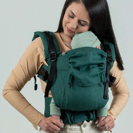 Isara The One - Evergreen Linen baby carrier worn by a parent with an infant, showcasing comfort and support | Babymaxi