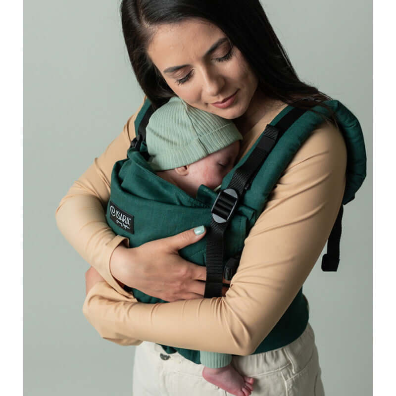 Isara The One - Evergreen Linen baby carrier with a mother holding a sleeping infant | Babymaxi