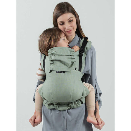 Isara The One - Sage Green Linen baby carrier worn by a parent, showcasing ergonomic design and soft linen fabric | Babymaxi