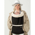 Woman wearing Isara Winter Baby Carrier Cover - Ultra Black, keeping baby warm in cozy fleece during winter.| Babymaxi
