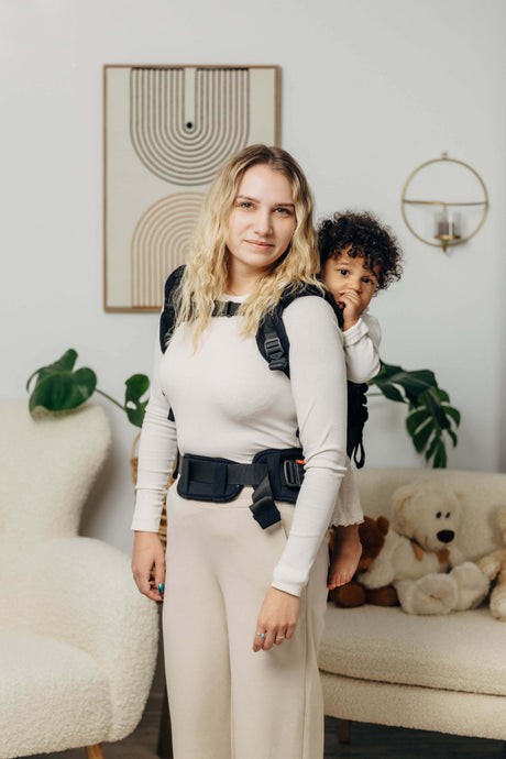 Mom using LennyLamb LennyPreschool (up to 30kg) - Little Herringbone Ebony Black baby carrier with a toddler | Babymaxi
