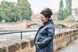 Mamalila Berlin All Season Babywearing Coat – Navy worn by a woman outdoors, stylish and practical for all seasons | Babymaxi