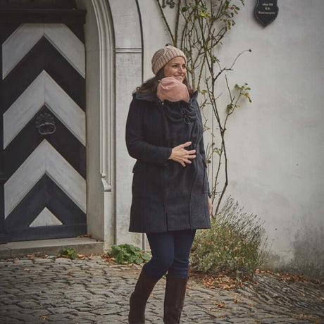 Mamalila Hooded Babywearing Coat Vienna - Anthracite worn by woman outdoors, featuring boiled wool, hood, and stylish design | Babymaxi
