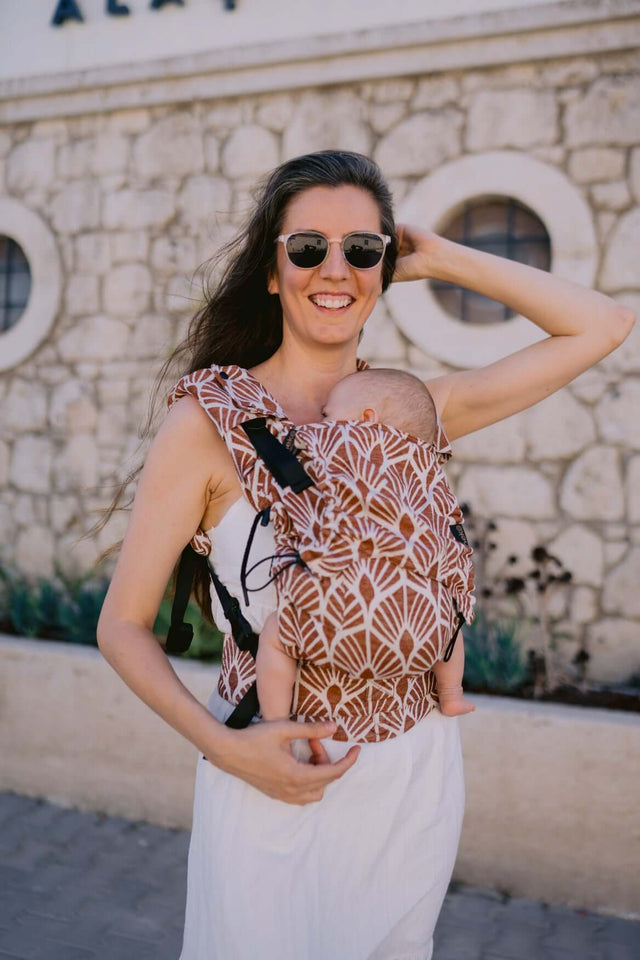 Mom wearing Neko Switch Baby Size - Mocha carrier with baby, stylish and comfortable, perfect for warm months | Babymaxi