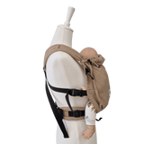 Stochenwiege Valeno Baby Carrier - Sand on mannequin with flexible straps and a baby doll | Babymaxi