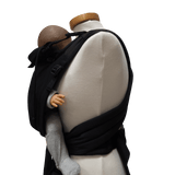 Storchenwiege Talemo Half-Buckle Baby Carrier - Black on mannequin with baby | Babymaxi