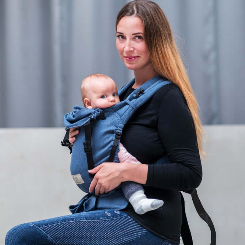 Mother using Storchenwiege Talemo Half-Buckle Baby Carrier - Denim to carry baby comfortably | Babymaxi